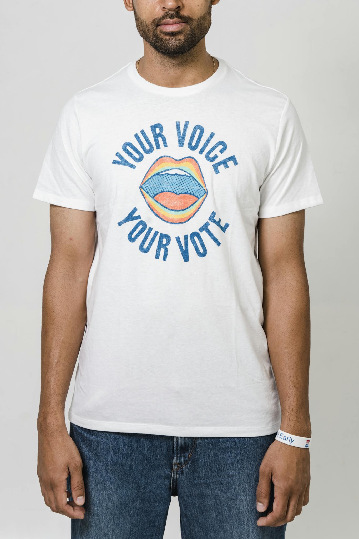 Bearded man in a 'Your Voice Your Vote' t-shirt, promoting democracy.